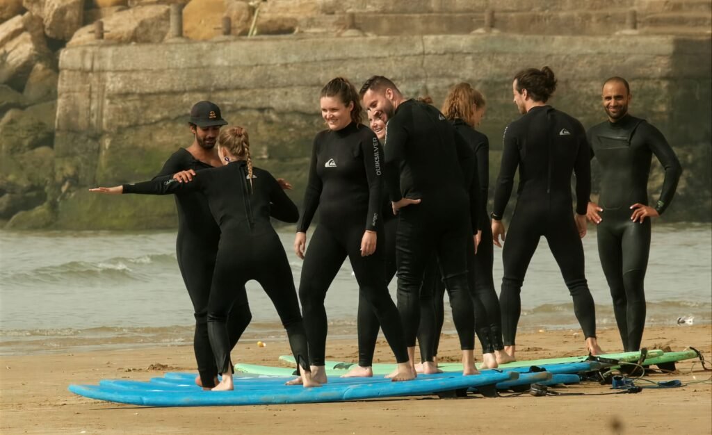 Local surf instructor in Imsouane giving personal feedback in the water